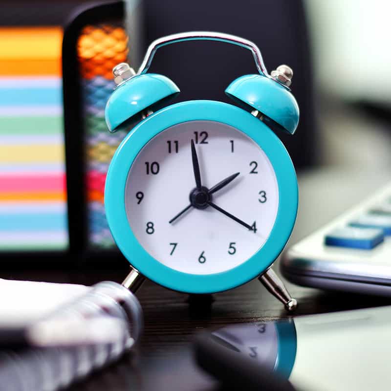 time A clock on a business owners desk reminding them they don't have time to do their own content marketing